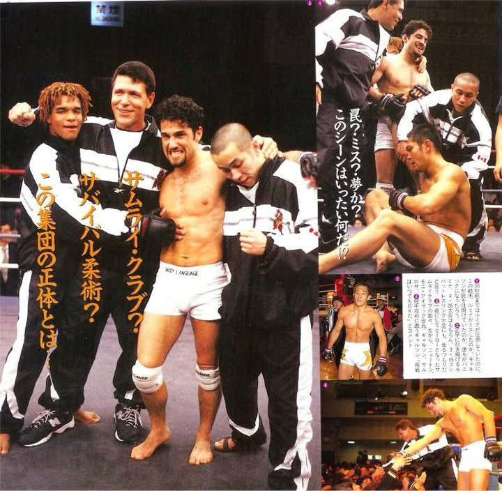 mma-debut-revmma Martial artists in a ring, celebrating in black and white tracksuits with Japanese text in the background.
